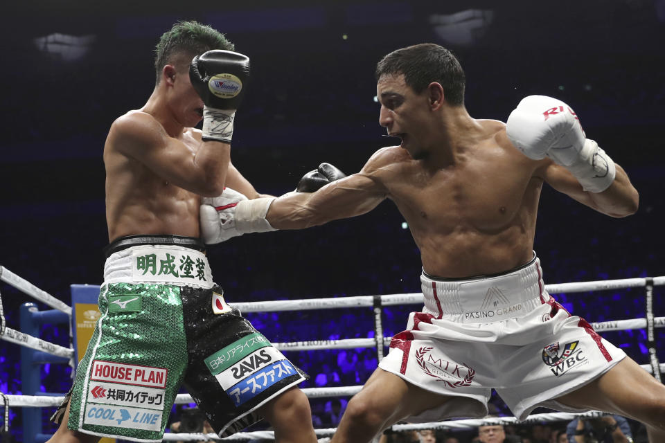 France's Nordine Oubaali, right, sends a right to Japan's Takuma Inoue in the sixth round of their WBC world bantamweight title match in Saitama, Japan, Thursday, Nov. 7, 2019. Oubaali defeated Inoue by a unanimous decision. (AP Photo/Toru Takahashi)