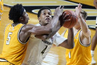 Vanderbilt guard Jordan Wright (4) tries to shoot between Valparaiso guards Donovan Clay (5) and Sigurd Lorange (1) in the first half of an NCAA college basketball game Friday, Nov. 27, 2020, in Nashville, Tenn. (AP Photo/Mark Humphrey)