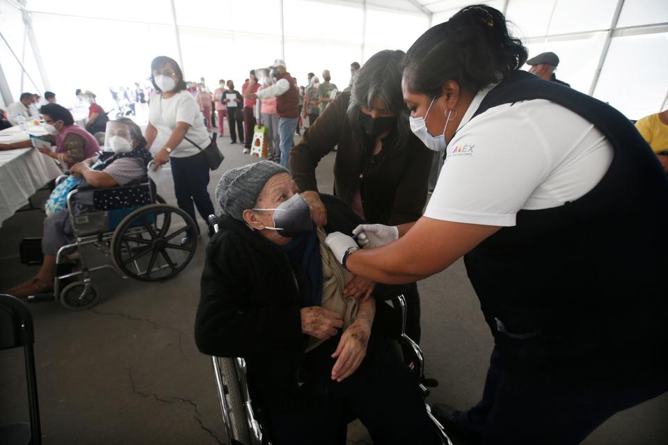 An elderly woman gets her Sinovac Biotech COVID-19 vaccine at the Americas sports center in Ecatepec, a borough on the outskirts of Mexico City, Tuesday, Feb. 23, 2021. (Foto AP/Marco Ugarte
