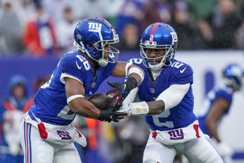 New York Giants quarterback Tyrod Taylor (2) hands the ball to New York Giants running back Saquon Barkley (26) during the first half of an NFL football game against the New York Jets, Sunday, Oct. 29, 2023, in East Rutherford, N.J. (AP Photo/Frank Franklin II)