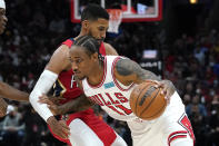 Chicago Bulls forward DeMar DeRozan, right, drives against New Orleans Pelicans forward Garrett Temple during the first half of an NBA basketball game in Chicago, Friday, Oct. 22, 2021. (AP Photo/Nam Y. Huh)