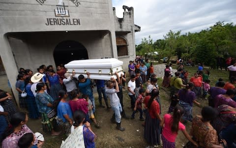 Relatives and friends of the family carry the coffin of Guatemalan seven-year-old Jakelin Caal, - Credit: AFP