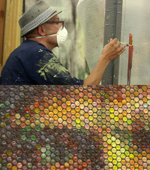 Bradley Hart injects acrylic paint into the air pockets of bubble wrap.   / Credit: CBS News