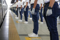 Police trainees join in a simulation exercise for proper social distancing at the LRT-2 train station on Tuesday, May 26, 2020 in Manila, Philippines. The exercise is held to prepare for the possible resumption of public transportation as the community lockdown to prevent the spread of the new coronavirus might be more relaxed next week. (AP Photo/Aaron Favila)