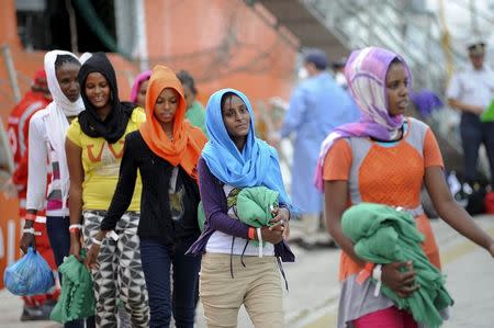 Migrants disembark from the Norwegian vessel Siem Pilot Stavanger in the Sicilian harbour of Palermo, Italy June 24, 2015. REUTERS/Guglielmo Mangiapane