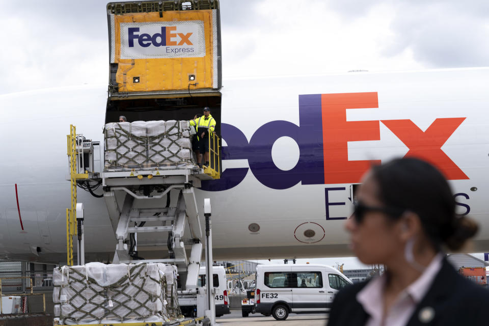 Workers unload a Fedex Express cargo plane carrying 100,000 pounds of baby formula at Washington Dulles International Airport, in Chantilly, Va., on Wednesday, May 25, 2022. (AP Photo/Jose Luis Magana)