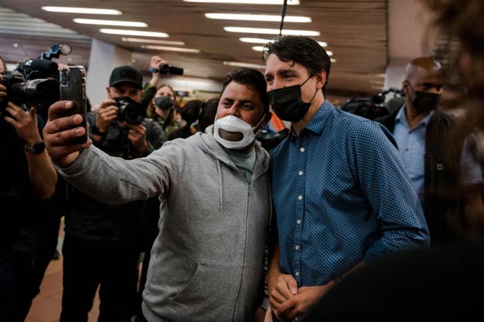 Justin taking a picture with someone during a campaign stop