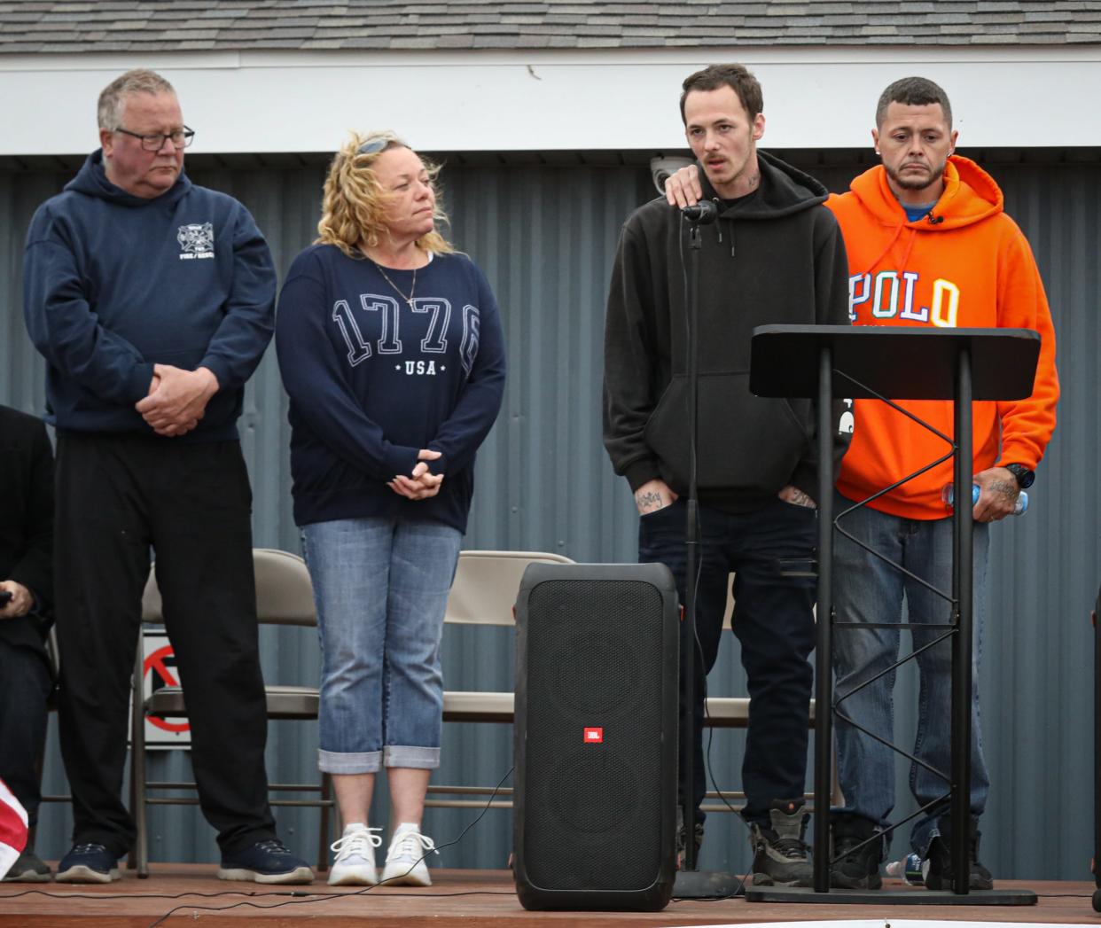 Nicholas Phillips and Michael Hatfield (right), both uncles to Alanah and Zayn Phillips, speak to the crowd at a vigil held at the Swan Boat Club, Newport on Friday. On the left is State Rep. Jamie Thompson, R-Brownstown Township, and Robert Cousino, Berlin Township fire chief.