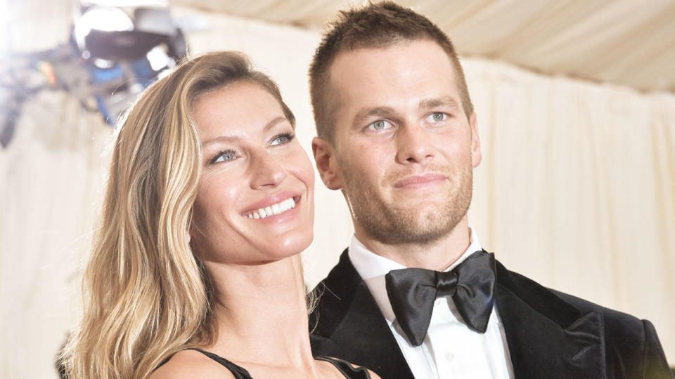 Tom Brady (pictured right) posing with with his model wife Gisele Bundchen (pictured left) at the "Charles James: Beyond Fashion" Costume Institute Gala.