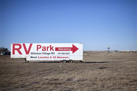 Signs are shown pointing to a Recreational Vehicle park outside of Williston, North Dakota February 9, 2014. REUTERS/Annie Flanagan