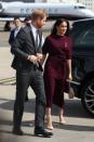 <p>Ever the chic traveller, Meghan wore a £249 Hugo Boss dress in a winter-ready berry hue for their departure from Sydney airport. <em>[Photo: Getty]</em> </p>