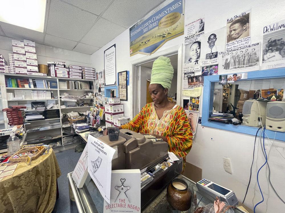 Maati Jone Primm looks down at her notes in her store Marshall’s Music and Bookstore in Farish Street Historic District, Thursday, Sept. 1, 2022 in Jackson, Miss. (AP Photo/Michael Goldberg)