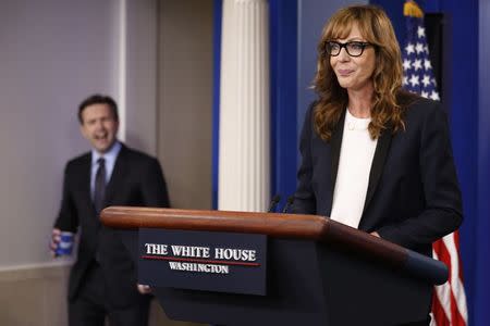 White House Press Secretary Josh Earnest (L) feigns shock that actress Allison Janney, who played a fictional press secretary in "The West Wing" television show, had commandeered the lectern before the daily press briefing at the White House in Washington, U.S., April 29, 2016. REUTERS/Jonathan Ernst