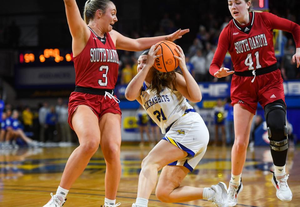 South Dakota State’s Paige Meyer attempts to keep the ball from South Dakota’s Macy Guebert and Alexi Hempe in a rivalry matchup on Saturday, January 14, 2023, at Frost Arena in Brookings.