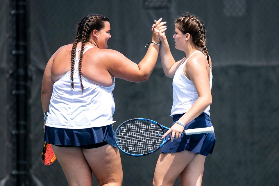 Cedar Rapids Xavier's Courtney Carstensen, left, and Ally Burger celebrate a point while competing in the doubles final during the Class 1A high school girls state tennis tournament on May 28 at the Hawkeye Tennis and Recreation Complex in Iowa City, Iowa.