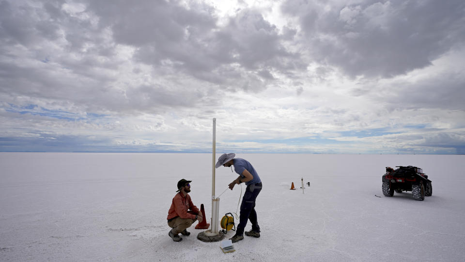 State biologists collects water samples in the Bonneville Salt Flats Tuesday, Sept. 13, 2022, near Wendover, Utah. The glistening white salt of the world famous area is shrinking near the Utah-Nevada line. (AP Photo/Rick Bowmer)