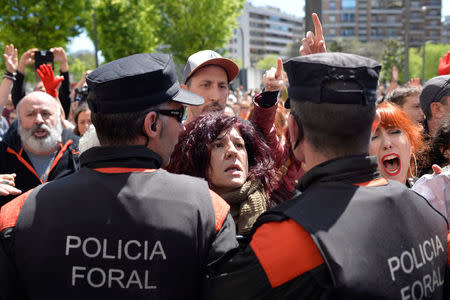 Protesters break through a police line after a nine-year sentence was given to five men accused of the multiple rape of a woman during Pamplona's San Fermin festival in 2016, in Pamplona, Spain, April 26, 2018. REUTERS/Vincent West