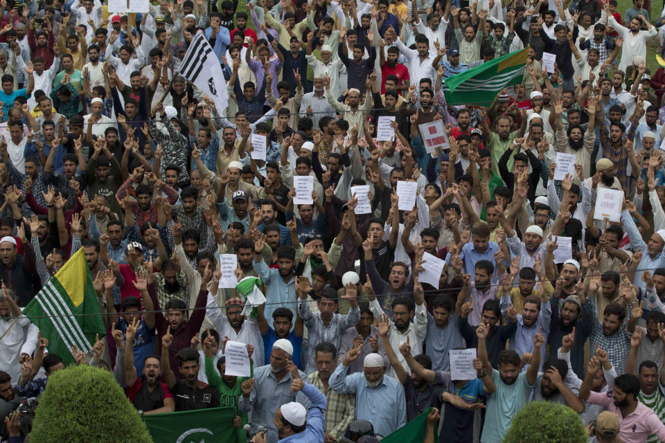 Kashmiri Muslims shout pro-freedom slogans at a demonstration after Friday prayers during curfew like restrictions in Srinagar, India, Friday, Aug. 16, 2019. India's government assured the Supreme Court on Friday that the situation in disputed Kashmir is being reviewed daily and unprecedented security restrictions will be removed over the next few days, an attorney said after the court heard challenges to India's moves.(AP Photo/Dar Yasin)