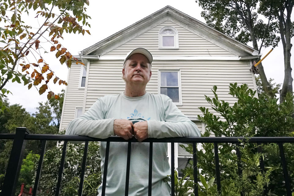 Landlord Rick Martin poses outside one of his properties in the Dorchester neighborhood, which he has decided not to rent out all of the units, Wednesday, Aug. 18, 2021, in Boston. Many landlords like Martin say they have suffered financially due to various state, local and federal eviction moratoriums in place since last year. (AP Photo/Charles Krupa)