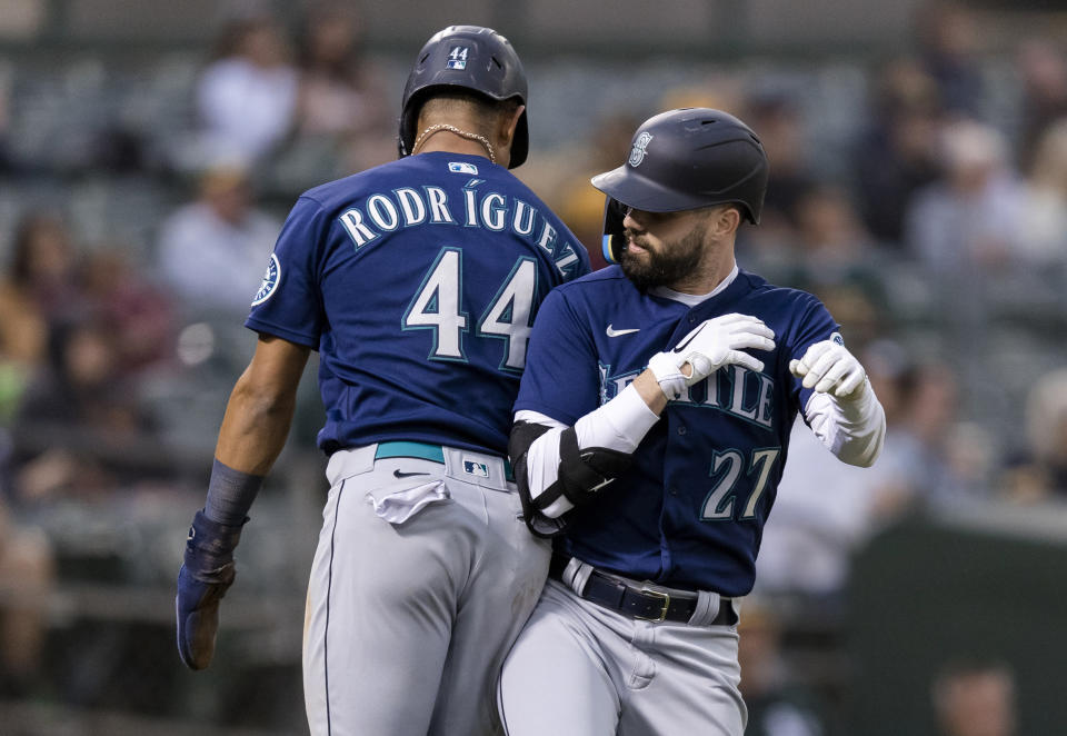 Seattle Mariners' Jesse Winker celebrates with Julio Rodriguez, left, after hitting a two-run home run against the Oakland Athletics during the fifth inning of a baseball game in Oakland, Calif., Wednesday, June 22, 2022. (AP Photo/John Hefti)