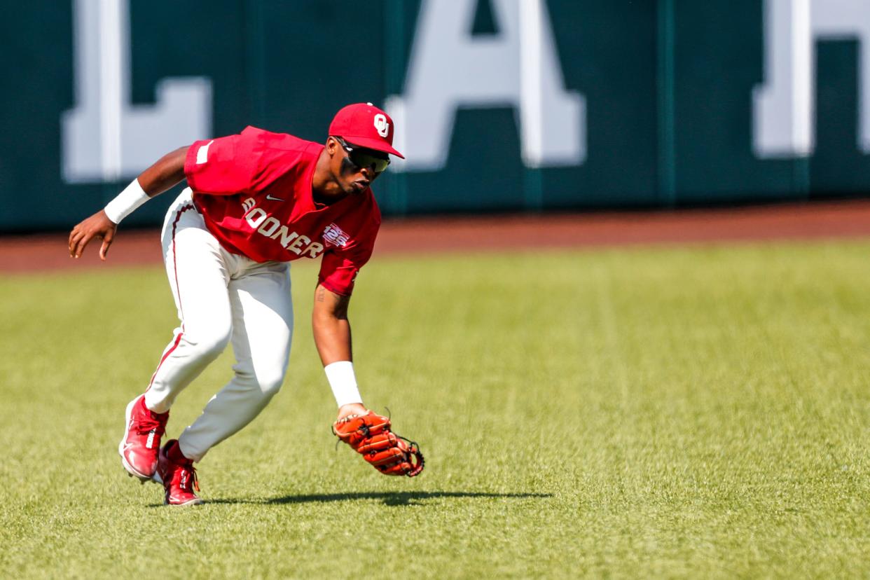 Oklahoma outfielder Kendall Pettis (7) fields the ball during the Bedlam baseball game between the Oklahoma Sooners and the Oklahoma State Cowboys at L. Dale Mitchell Park in Norman, Okla., on Saturday, May 20, 2023.