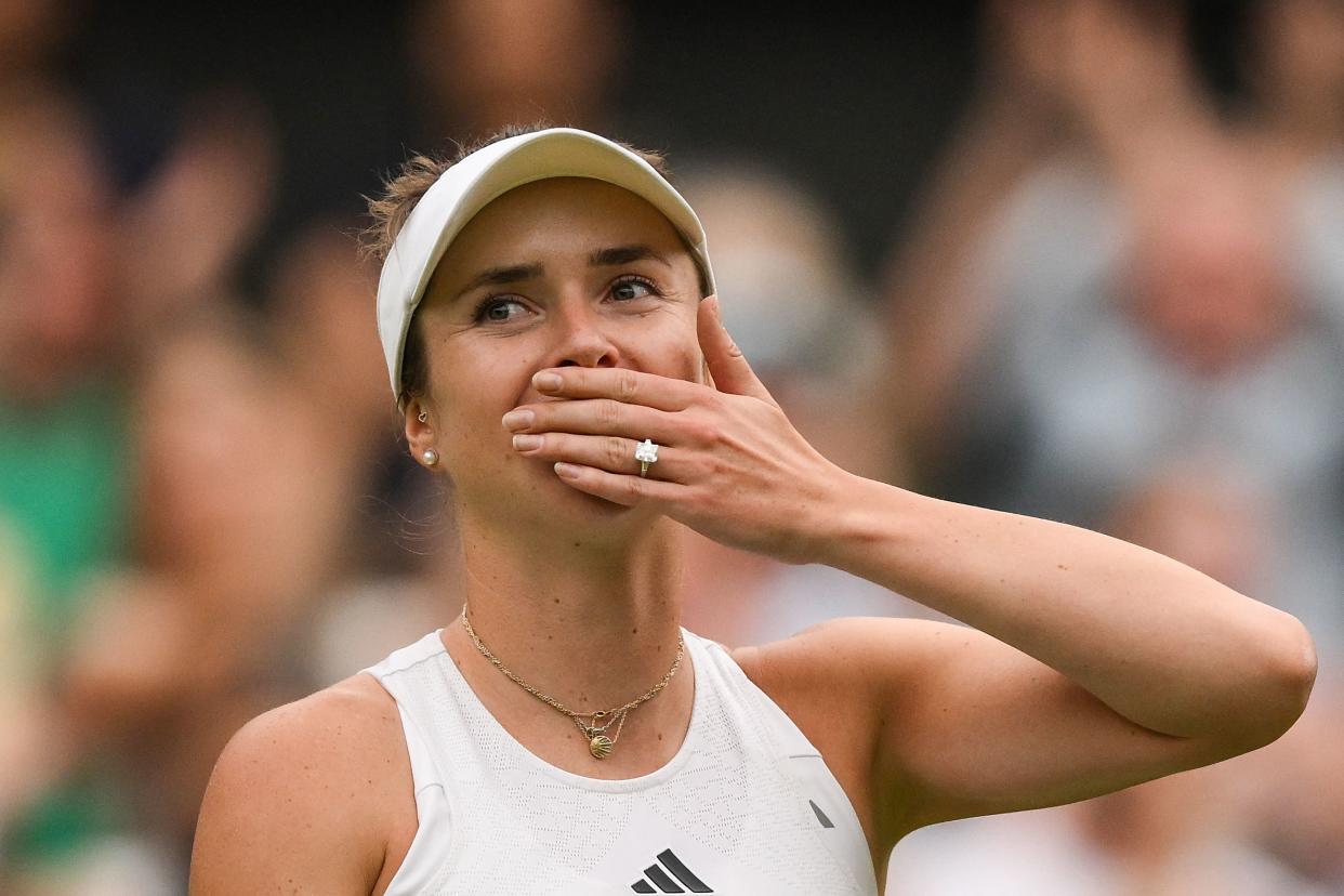 Ukraine's Elina Svitolina blows a kiss as she celebrates winning against Poland's Iga Swiatek during their women's singles quarter-finals tennis match on the ninth day of the 2023 Wimbledon Championships at The All England Tennis Club in Wimbledon, southwest London, on July 11, 2023. (Photo by Daniel LEAL / AFP) / RESTRICTED TO EDITORIAL USE (Photo by DANIEL LEAL/AFP via Getty Images)