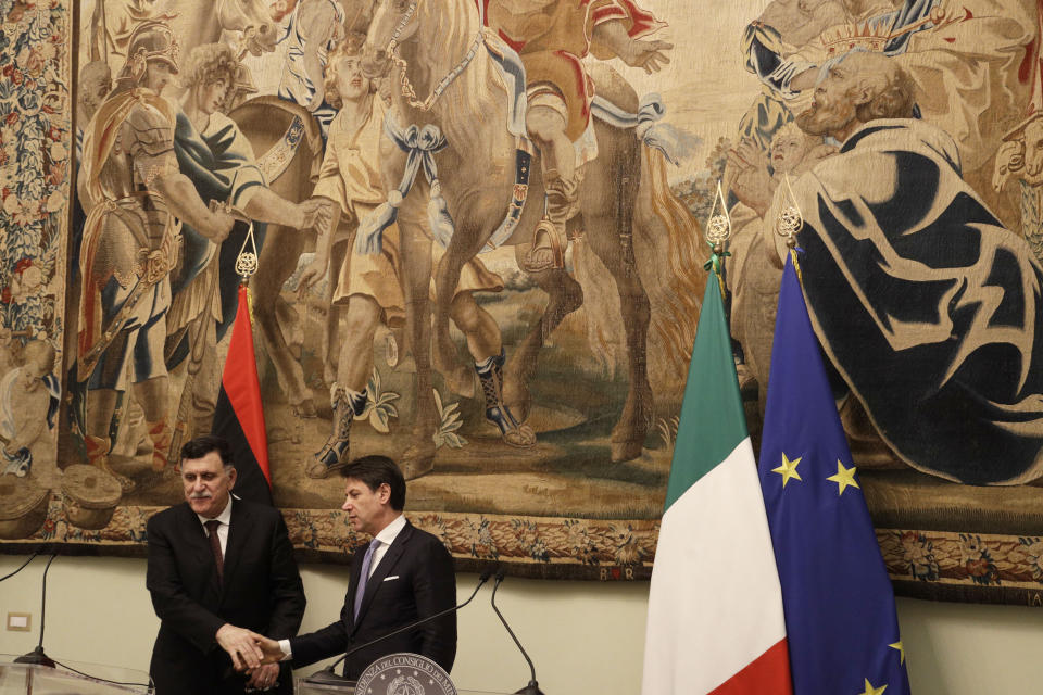 Libya's Prime Minister Fayez al-Sarraj, left, shakes hands with Italian Premier Giuseppe Conte after their meeting at Chigi palace, in Rome, Saturday, Jan. 11, 2020. (AP Photo/Gregorio Borgia)