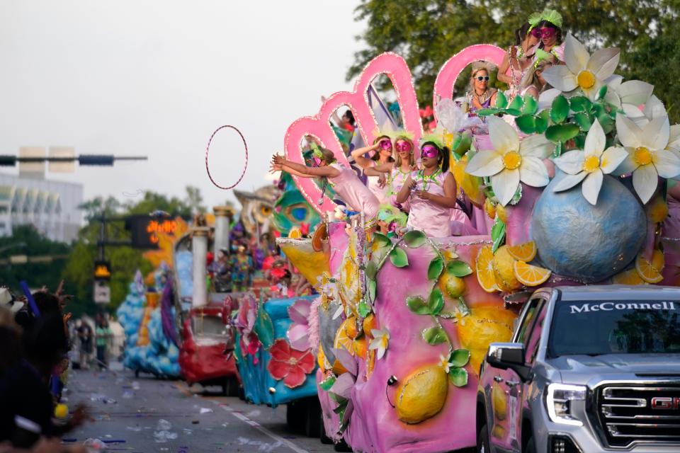 A trinket is thrown from a float during a parade in Mobile, Ala., dubbed “Tardy Gras,” to compensate for canceled Mardi Gras festivities because of the COVID-19 pandemic.