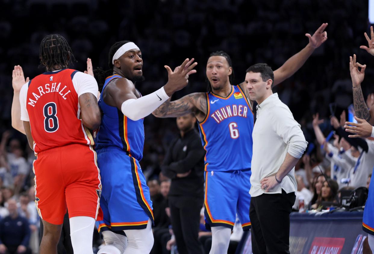 Oklahoma City Thunder guard Luguentz Dort (5) celebrates a 3-pointer beside New Orleans Pelicans forward Naji Marshall and Thunder coach Mark Daigneault forward Jalen Williams (8) during Game 2 of the NBA basketball playoff series between the Oklahoma City Thunder and the New Orleans Pelicans at Paycom Center in Oklahoma City, Wednesday, April 24, 2024. Oklahoma City won 124-92.