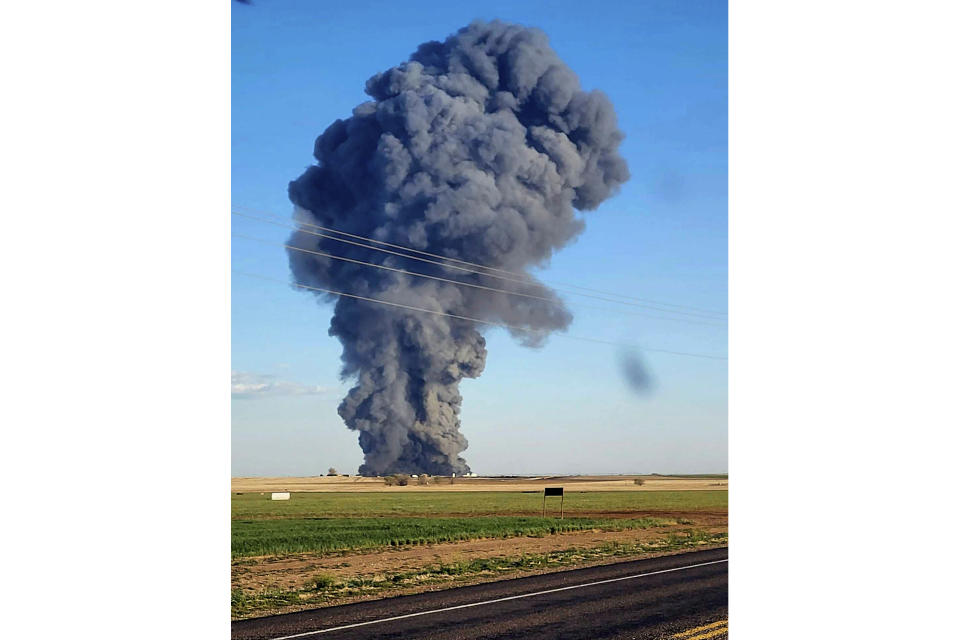 In this photo provided by Castro County Emergency Management, smoke fills the sky after an explosion and fire at the Southfork Dairy Farms near Dimmitt, Texas, on Monday, April 10, 2023. The explosion at the dairy farm in the Texas Panhandle that critically injured one person and killed an estimated 18,000 head of cattle is the deadliest barn fire recorded since the Animal Welfare Institute began tracking the fires. (Castro County Emergency Management via AP)