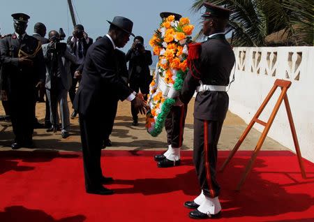 Ivory Coast's President Alassane Ouattara prepares to lay a wreath for those killed in Sunday's attack by Al Qaeda in the Islamic Maghreb, on a beach in Grand Bassam March 16, 2016. REUTERS/Luc Gnago