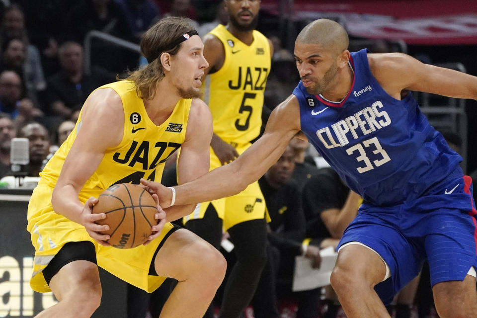 Los Angeles Clippers forward Nicolas Batum, right, steals the ball from Utah Jazz forward Kelly Olynyk during the second half of an NBA basketball game Monday, Nov. 21, 2022, in Los Angeles. (AP Photo/Mark J. Terrill)