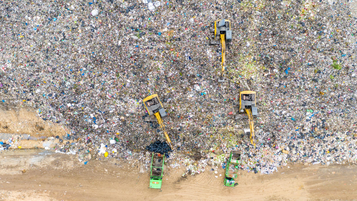 Aerial shot top view Garbage trucks unload garbage to a recycle in the vicinity of the city of Bangkok, Thailand