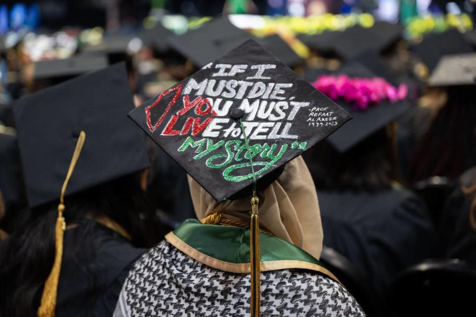 Eman Ahmed Salem, a Sacramento State English major, wears a mortarboard decorated with a poem by Palestinian professor and poet Refaat Alareer during the commencement ceremony at Golden 1 Center on Friday, May 17, 2024. Alareer died after an Israeli missile strike on December 2023.
