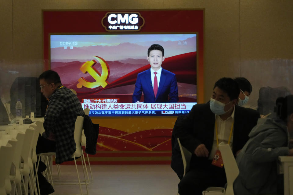 Chinese journalists work near a screen showing content from China Media Group, a grouping of all Chinese state-media, at a press conference held on the sidelines of the 20th Party Congress in Beijing on Oct. 20, 2022. China's ruling Communist Party has long relied on a critically important and secretive internal reference system to learn about issues considered too sensitive for the public to know. But as Chinese leader Xi Jinping tightens censorship and consolidates his rule, Chinese academics and journalists say even this internal system is struggling to give frank assessments. (AP Photo/Ng Han Guan)