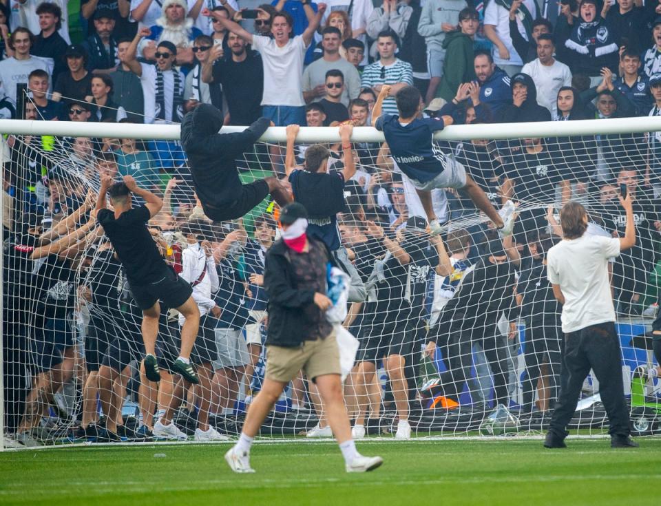 Melbourne Victory fans invade the pitch (AP)