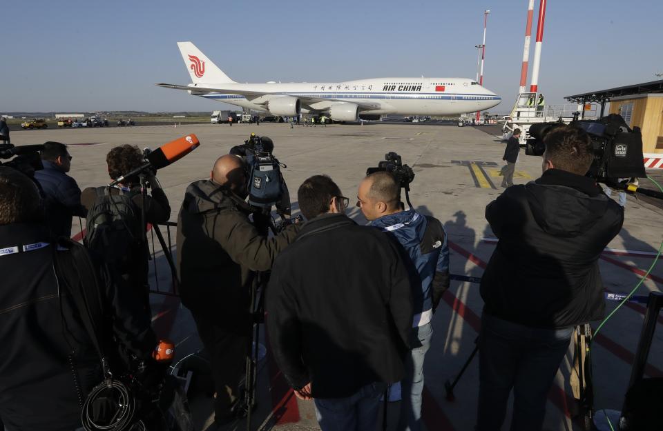 Reporters film the Chinese delegation's airplane after landing at Rome's Leonardo Da Vinci airport in Fiumicino, Italy, Thursday, March 21, 2019. Chinese President Xi Jinping is visiting Italy to sign a memorandum of understanding to make Italy the first Group of Seven leading democracies to join China's ambitious Belt and Road infrastructure project. (AP Photo/Andrew Medichini)