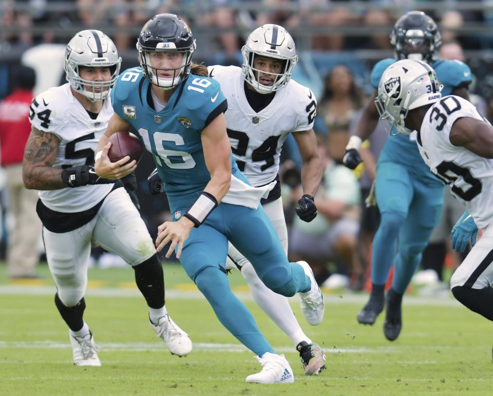 Jacksonville Jaguars quarterback Trevor Lawrence (16) scrambles for a first down during late second quarter action. The Jacksonville Jaguars hosted the Las Vegas Raiders at TIAA Bank Field in Jacksonville, FL Sunday November 6, 2022. The Jaguars trailed 20 to 10 at the end of the first half. [Bob Self/Florida Times-Union]