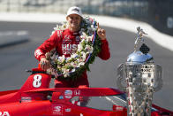 Marcus Ericsson, of Sweden, poses with the Borg-Warner Trophy during the traditional winners photo session at Indianapolis Motor Speedway in Indianapolis, Monday, May 30, 2022. Ericsson won the 106th running of the Indianapolis 500 auto race Sunday. (AP Photo/Michael Conroy)