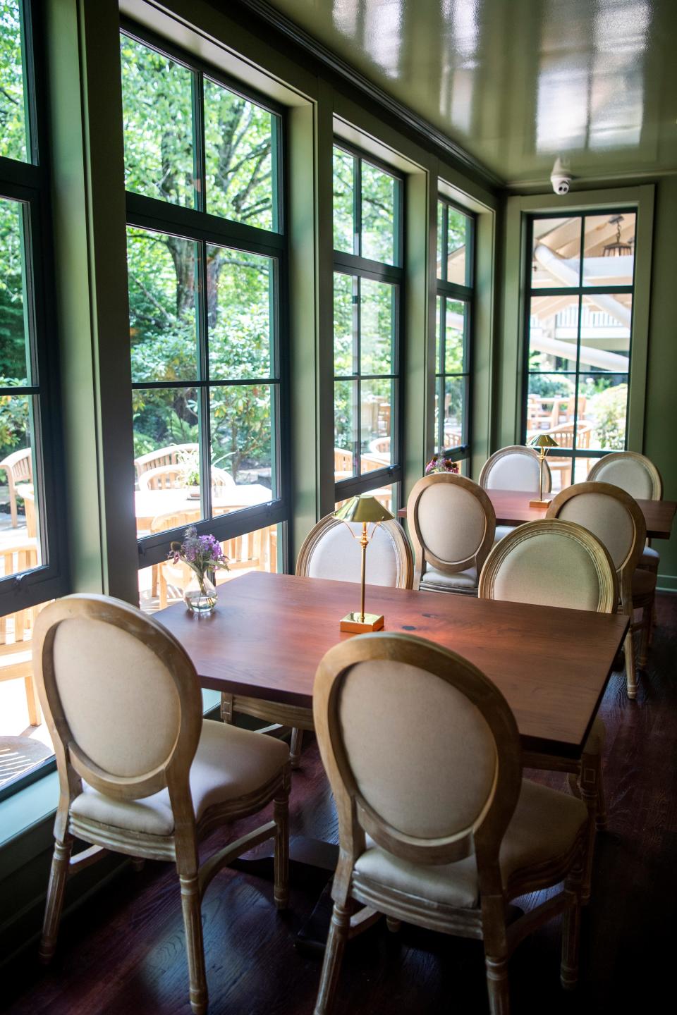 Window-side tables overlook a patio area at the Morningside Room bar at RT Lodge in Maryville on Thursday, July 21, 2022. The lodge, originally built as a private residence Susan Walker, has served as a presidential residence, a restaurant retreat and a hotel over the years.