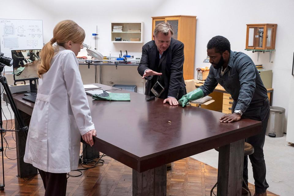 Director Christopher Nolan (center) goes over a scene with Clémence Poésy and John David Washington on the set of "Tenet."