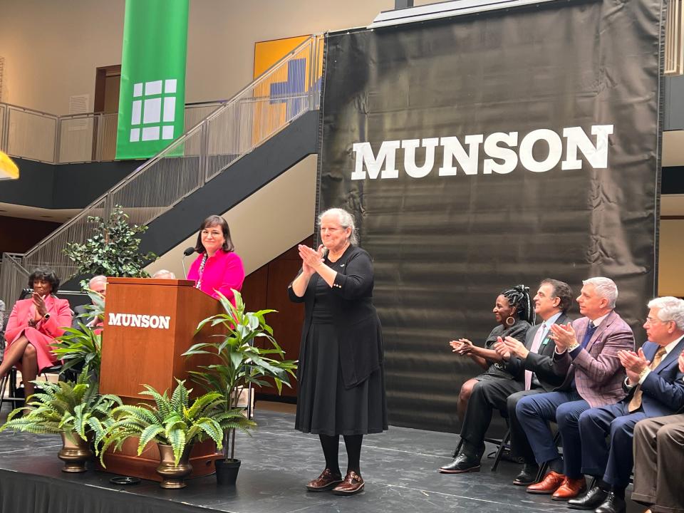 Munson President and CEO Anna Tobin D’Ambrosio, standing behind the podium, announces the name change for Munson on Tuesday, March 28.