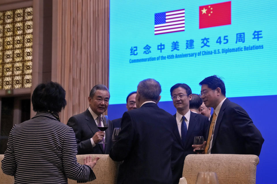 Chinese Foreign Minister Wang Yi, second left, toasts with invited guests after delivering a speech at a reception for Commemoration of the 45th Anniversary of China-U.S. Diplomatic Relations at the Diaoyutai Guest House in Beijing, Friday, Jan. 5, 2024. (AP Photo/Andy Wong, Pool)