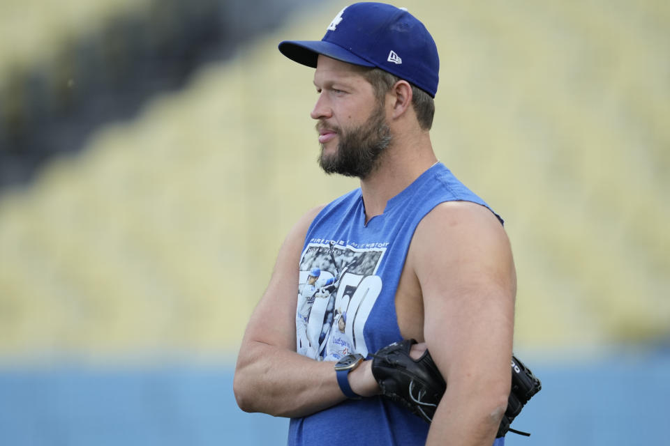 Los Angeles Dodgers pitcher Clayton Kershaw stands on the field during practice in preparation for Game 1 of a baseball NL Division Series against the San Diego Padres in Los Angeles, Friday, Oct. 4, 2024. (AP Photo/Ashley Landis)