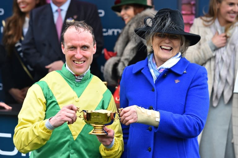 Jockey Robbie Power (L) and Irish trainer Jessica Harrington celebrate winning the Gold Cup with their horse Sizing John on the last day of the Cheltenham Festival at Cheltenham Racecourse in Gloucestershire, south-west England, on March 17, 2017