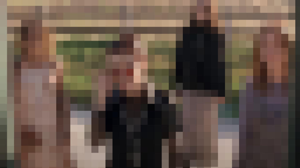 The witches from The Craft standing in front of a bus door, pixelated.