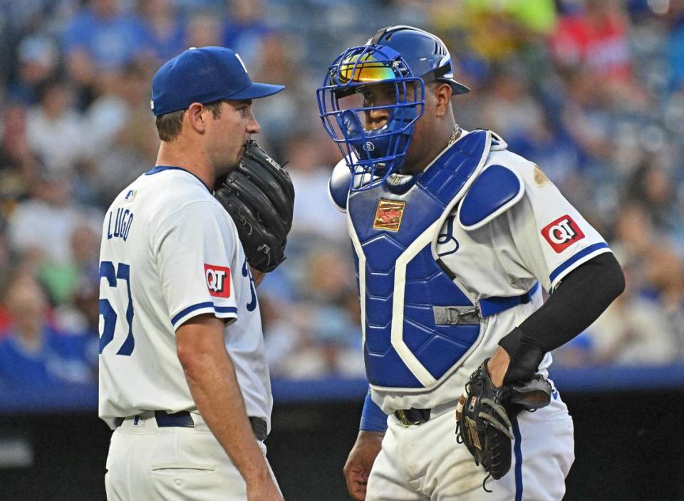 Kansas City Royals starting pitcher Seth Lugo (67) talks with catcher Salvador Perez (13) in the fifth inning against the Miami Marlins at Kauffman Stadium on Jun 25, 2024 in Kansas City, Missouri, USA.