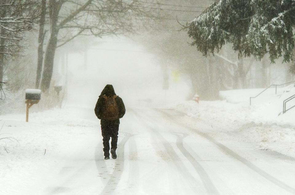A man walks through blowing snow on Pleasant Street in Ashburnham Thursday morning.