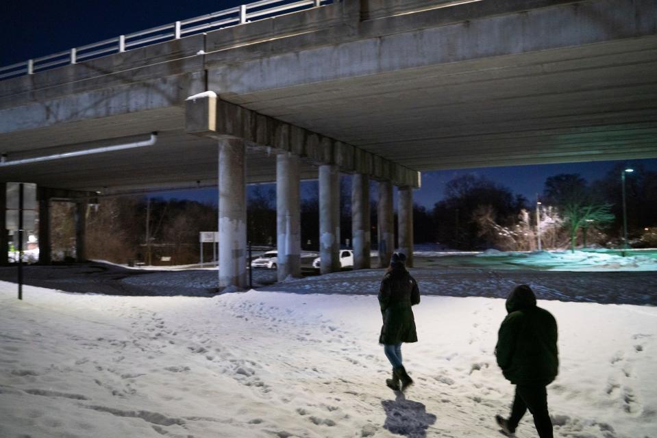 Lighthouse housing programs lead Brianna Agnello, 37, left, and Lighthouse case manager Teaghen Sehl, 24, of Chesterfield, search an area near the Clinton River Trail for the annual Point-in-Time (PIT) count of people experiencing homelessness in Rochester on Jan. 30, 2023.