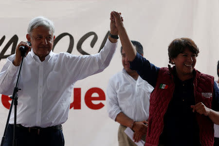 Delfina Gomez of the National Regeneration Movement (MORENA), candidate for the governor of the State of Mexico, hold hands with to Andres Manuel Lopez Obrador, leader of (MORENA) during her electoral campaign in Metepec, State of Mexico, Mexico May 16, 2017. Picture taken on May 16, 2017. REUTERS/Carlos Jasso